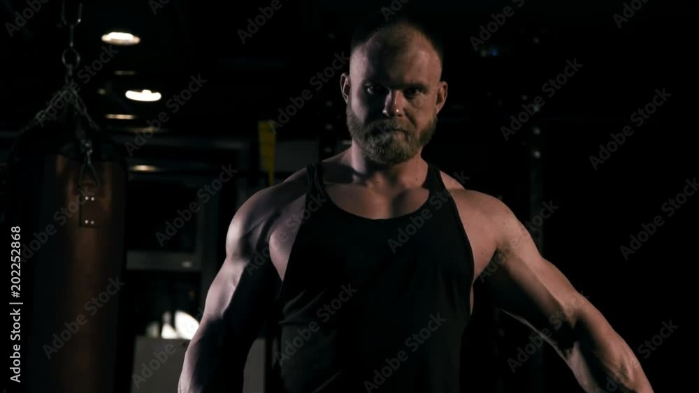 Strong man in training with a hammer and wheel Strong man in training with a hammer and wheel