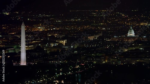 Over Washington DC cityscape at night, Washington Monument and Capitol in distance. Shot in 2011.