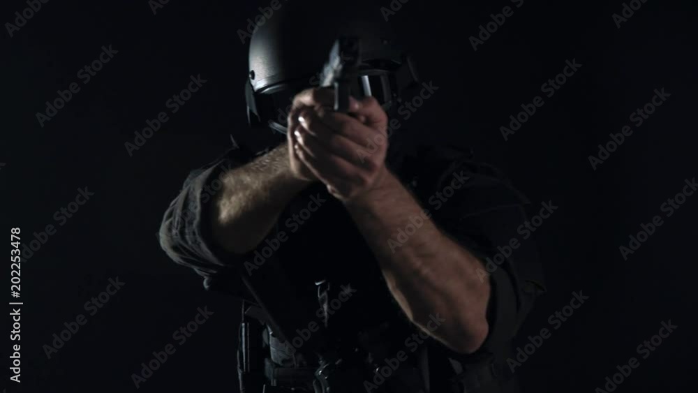 Spec ops police officer SWAT in black uniform studio Spec ops police officer SWAT in black uniform studio