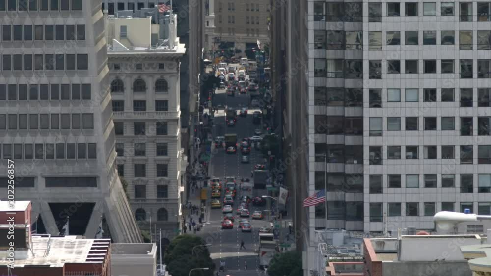 Time-lapse view looking down into San Francisco street between tall buildings Time-lapse view looking down into San Francisco street between tall buildings
