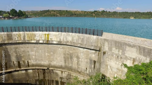 Dam wall with blue water of the reservoir photo