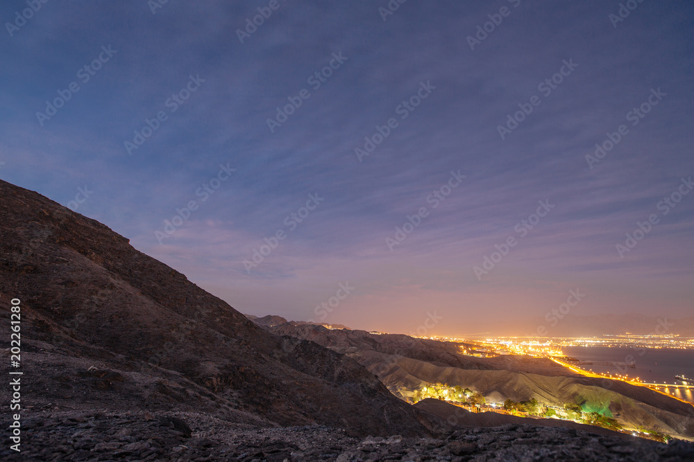 Suburb of Eilat city in the desert in the Israil in the evening with blue sky and city lights Suburb of Eilat city in the desert in the Israil in the evening with blue sky and city lights