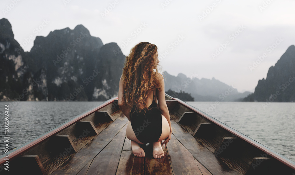 Beautiful woman posing on a boat - obrazy, fototapety, plakaty 