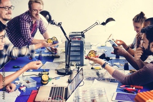 Electrical technicians working on robot electronics parts