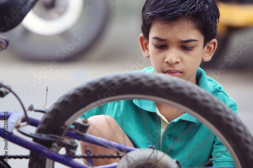 Indian Little Boy repairing cycle