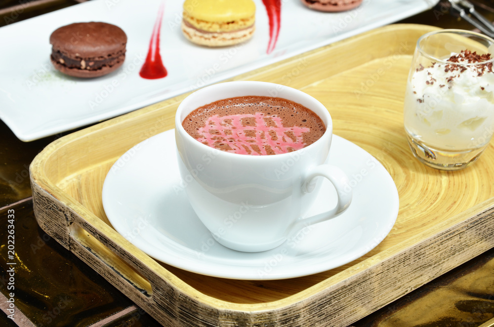 A cup of raspberry hot cocoa on wooden tray A cup of raspberry hot cocoa on wooden tray
