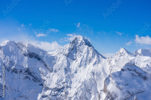 Stunning panoramic view of the Swiss Alps from the top of the Schilthorn mountain in the Jungfrau region of the country photo