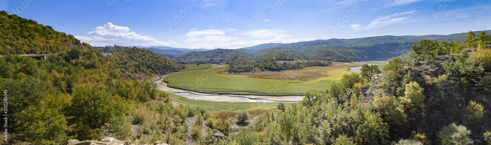 Panorama of valley with river bank after water flood