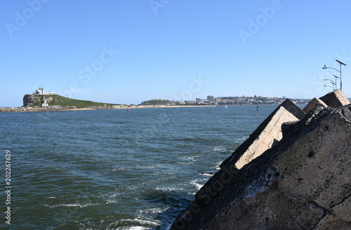 Wallpaper Mural Shipwreck breakwall at Stockton (Newcastle, NSW, Australia). Nobbys Lighthouse in the background. Torontodigital.ca