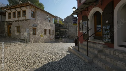 Kujundziluk street with restaurants and shops, Mostar photo