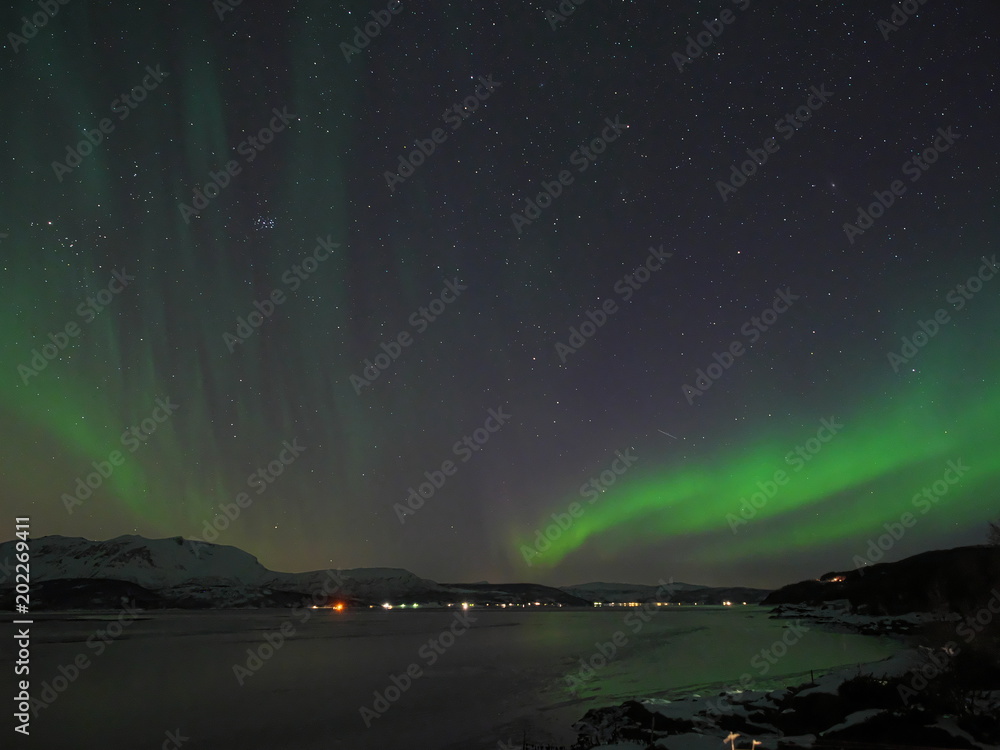Aurora spreading over Norway's fjord