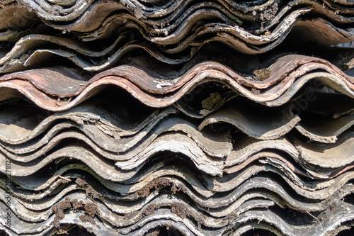 A Lot of Old Wavy Slates for Roof Placed on Each Other and Covered with Moss and Lichens