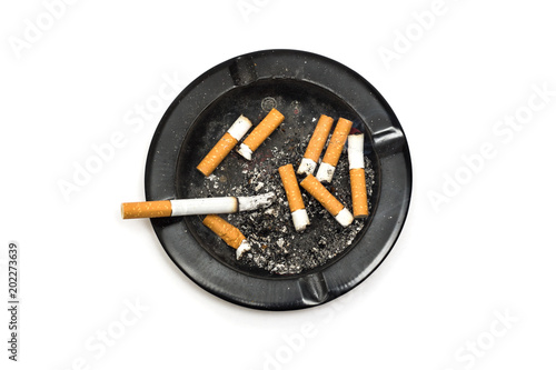 Принти на полотні Ashtray with smoking cigarette and cigarette butts on white background