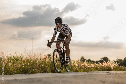 man ride on bike on the road active life concept sunset time