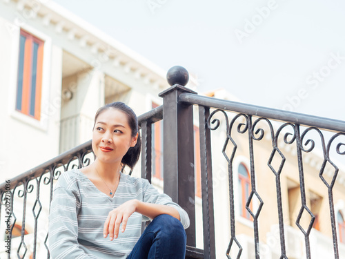 Tourist girl relax on the bridge with beautiful European buildng in the background. photo