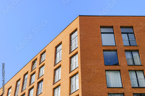 Details of office building exterior. Business buildings skyline looking up with blue sky. Modern architecture apartment. High tech exterior. Reflective buildings. Office Skyscraper. Glass office.