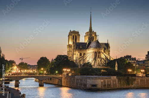 Notre Dame de Paris  France at sunset with view of Seine river and bridge