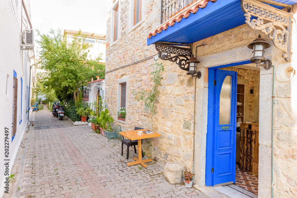 Narrow streets of Bodrum  with cafe table and chairs