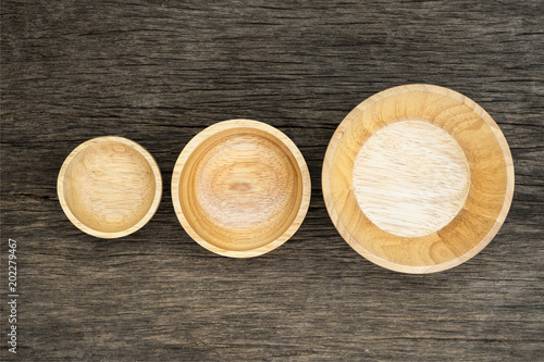 Top view of wooden three bowl on wooden background