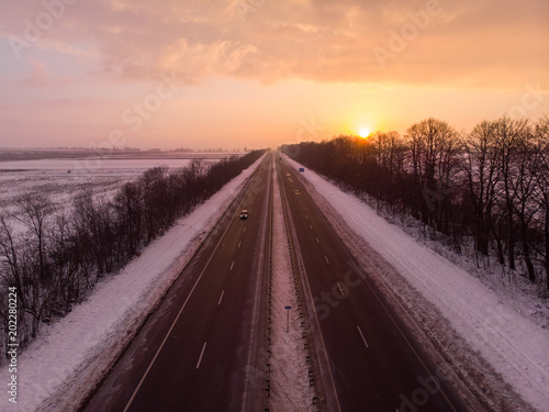 beautiful sunrise aerial view above highway. car travel concept