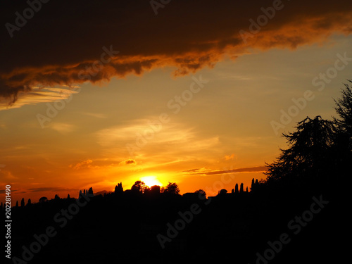 Fiery sunset from the old city of Bergamo to the hills surrounding the town
