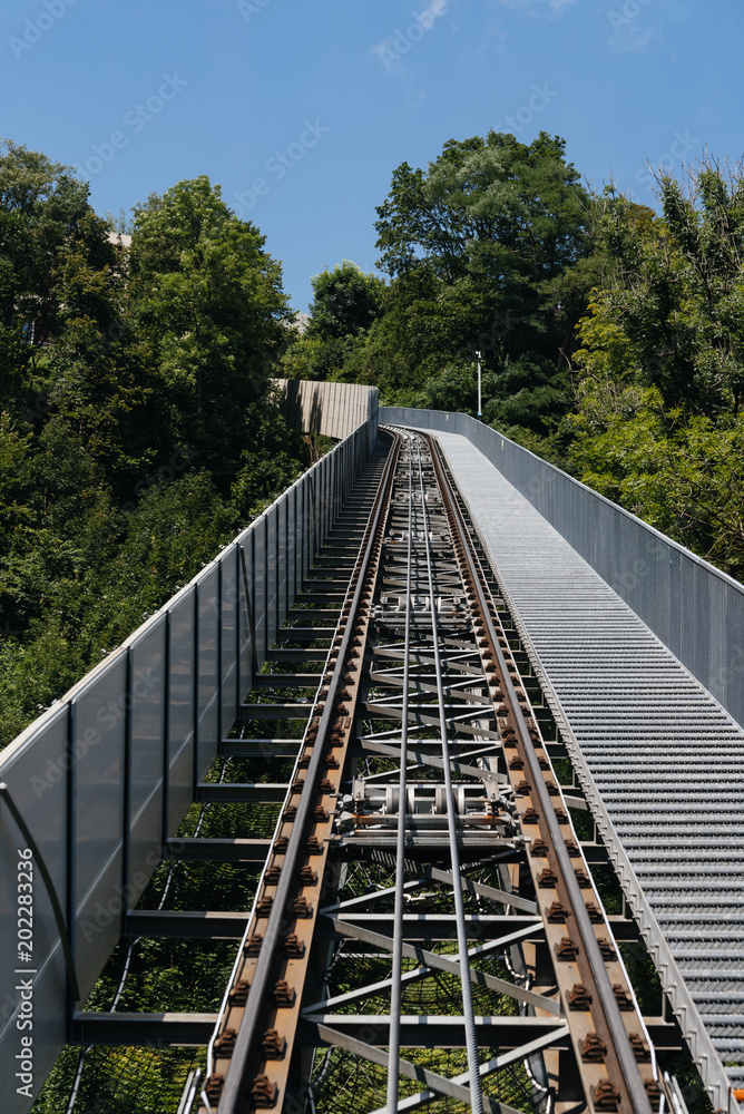 Cable railway bridge against Alps mountains Cable railway bridge against Alps mountains