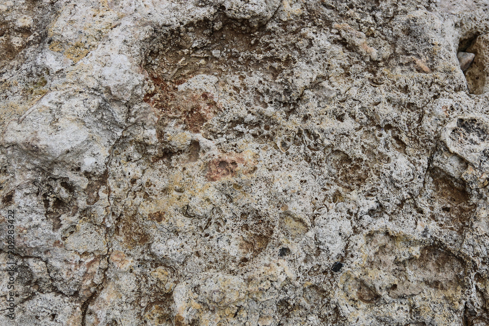 Naklejka premium Close-up rough grungy cracked stone texture background.