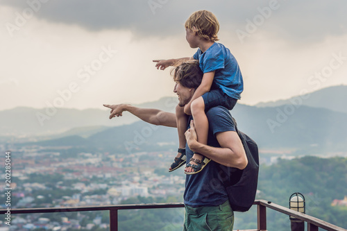 Father and son in the background of Phuket Town view from monkey Hill photo