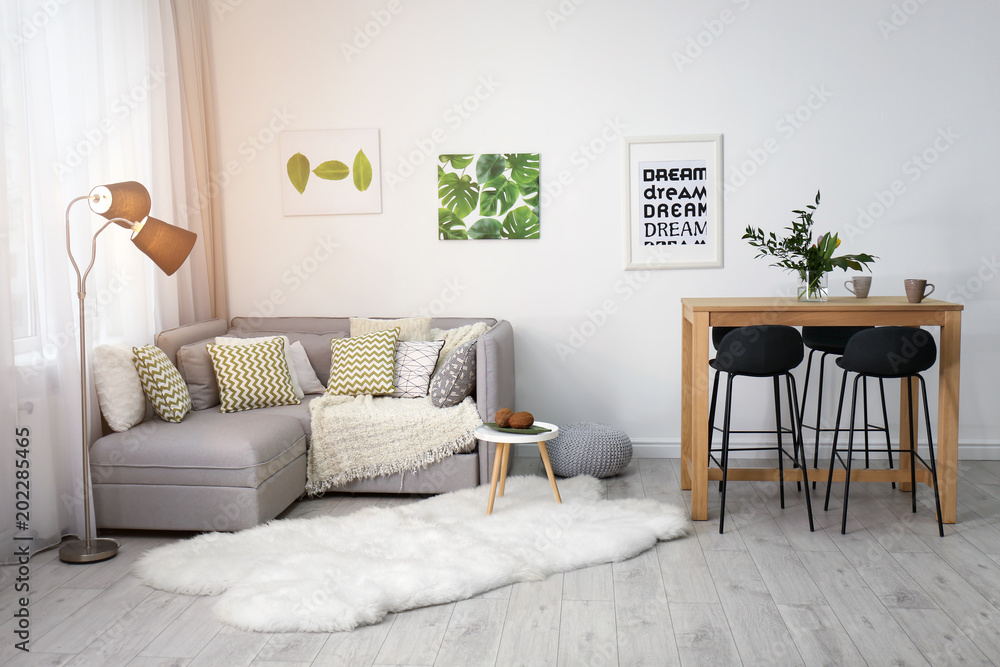 Fototapeta premium Beautiful room interior with comfortable sofa and stylish table