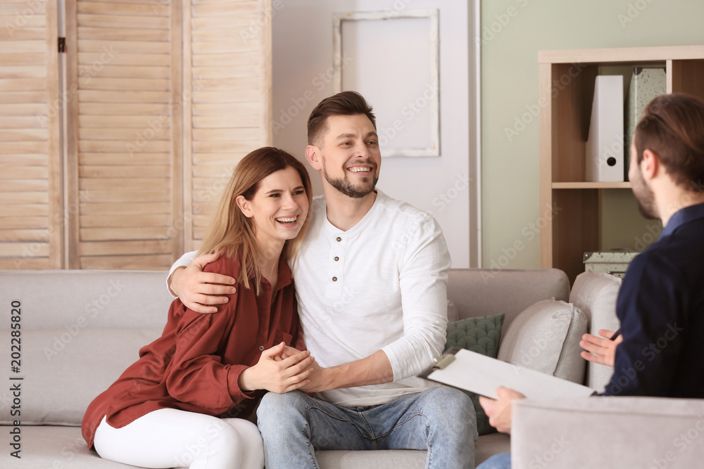 Family psychologist working with young couple in office Family psychologist working with young couple in office