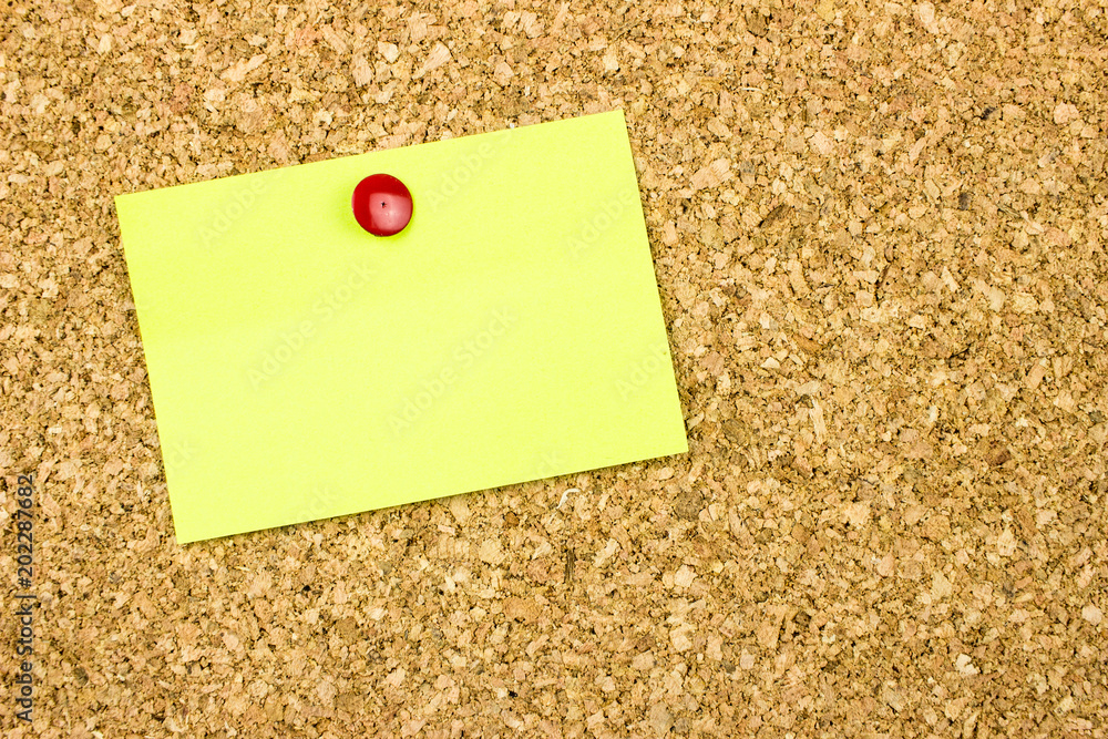 Pinned yellow paper. Cork background. Template for your message