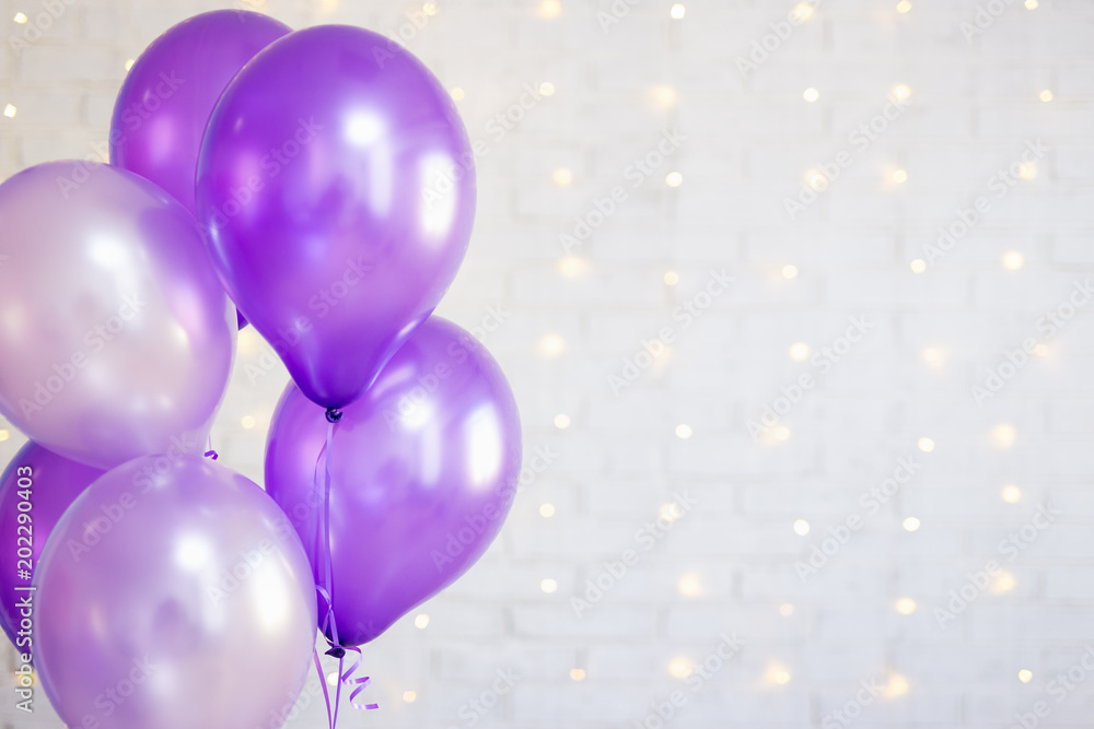 holiday concept - close up of air balloons over brick wall background with lights holiday concept - close up of air balloons over brick wall background with lights