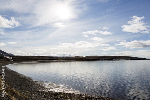 Panorama of a fjord with mountains in the background on a sunny day in Spitsbergen, Norway