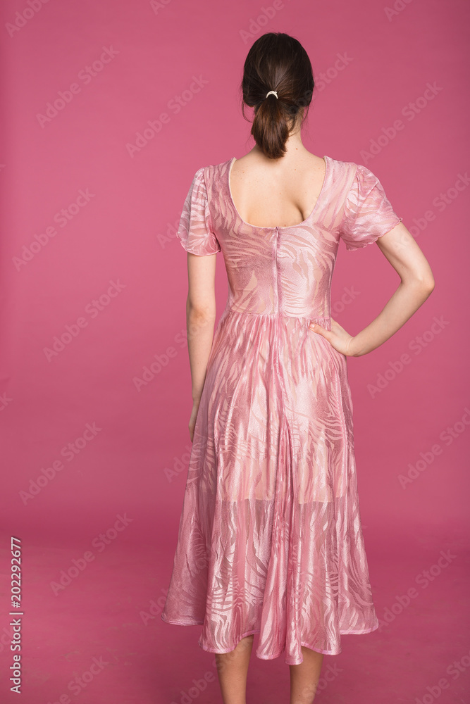 satin dress on a girl on a pink background
