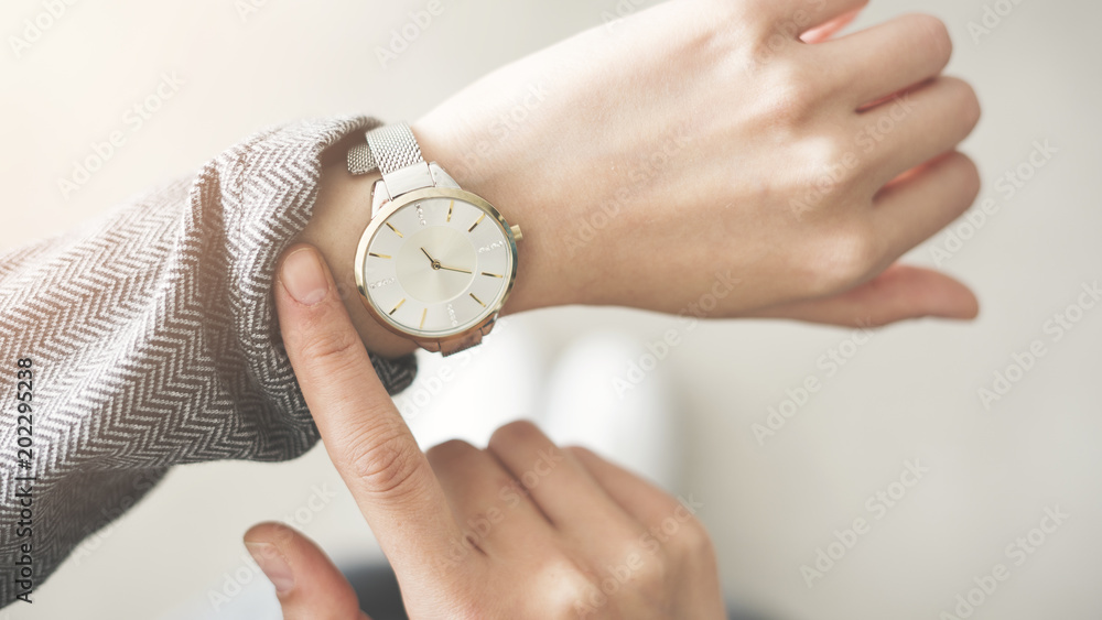 Woman checking time her watch