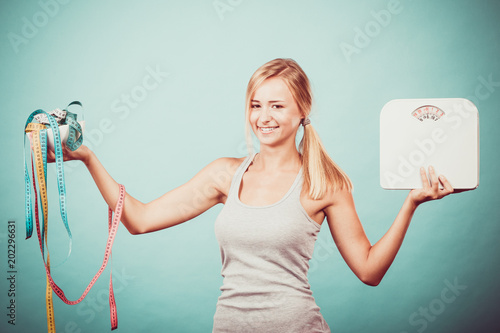 Girl with scales measuring tapes. Weight loss.