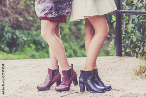 Two women presenting shoes outdoor