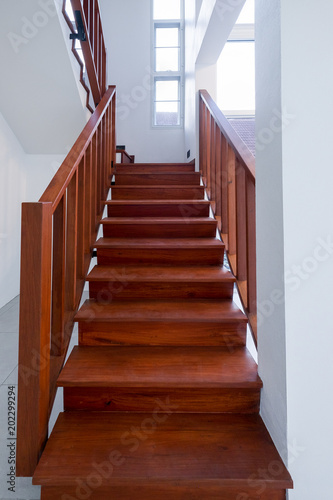 The interior design of wood stair is a modern style in the white house. © sirintra