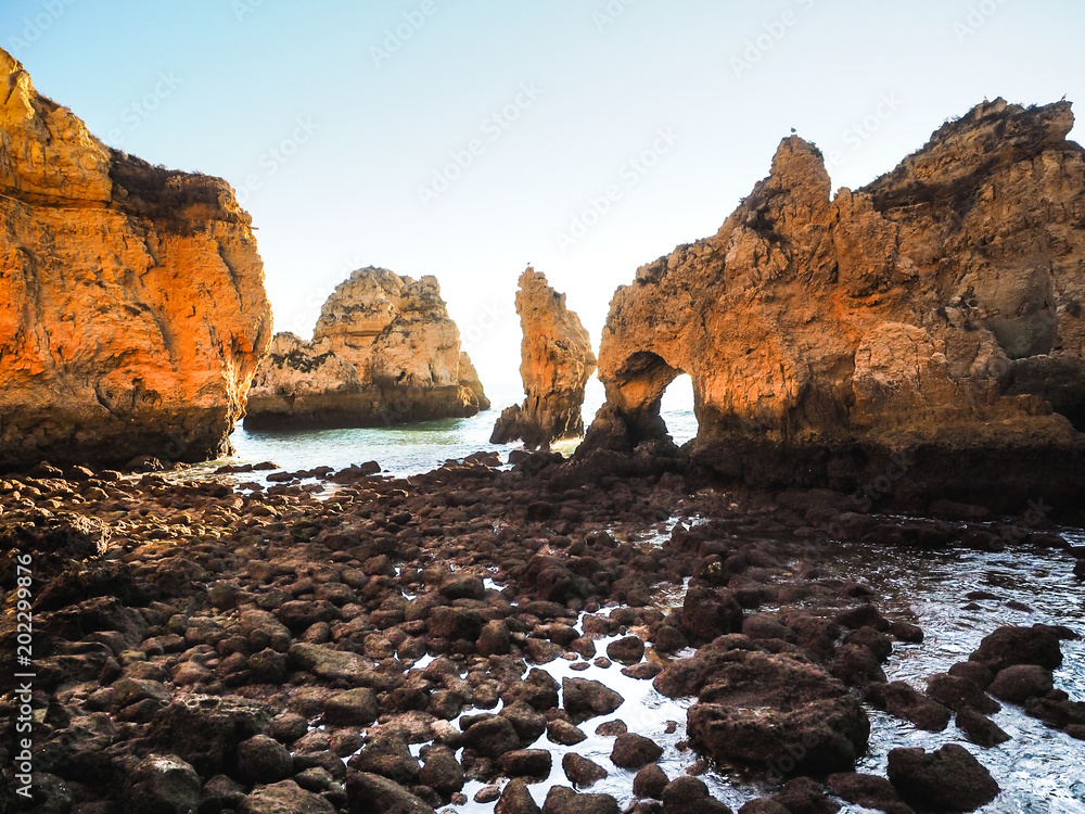 Algarve Sunrise over cliffs and Beach with Ocean View Panorama Outdoor Scene in Ponta da Piedade, Lagos, Portugal at Dusk. Algarve Sunrise over cliffs and Beach with Ocean View Panorama Outdoor Scene in Ponta da Piedade, Lagos, Portugal at Dusk.