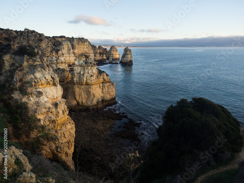 Algarve Sunrise over cliffs and Beach with Ocean View Panorama Outdoor Scene in Ponta da Piedade, Lagos, Portugal at Dusk