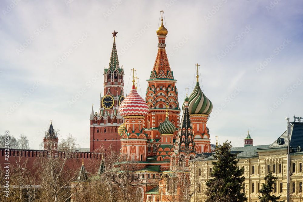 Moscow Kremlin Spasskaya tower and St Basil's Cathedral on the Red Square in Moscow, Russia.
