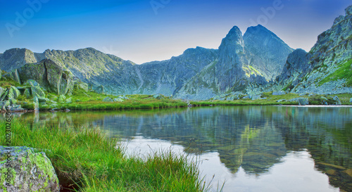 beautiful lake with mountain reflection in Retezat, Romania. Carpathians photo