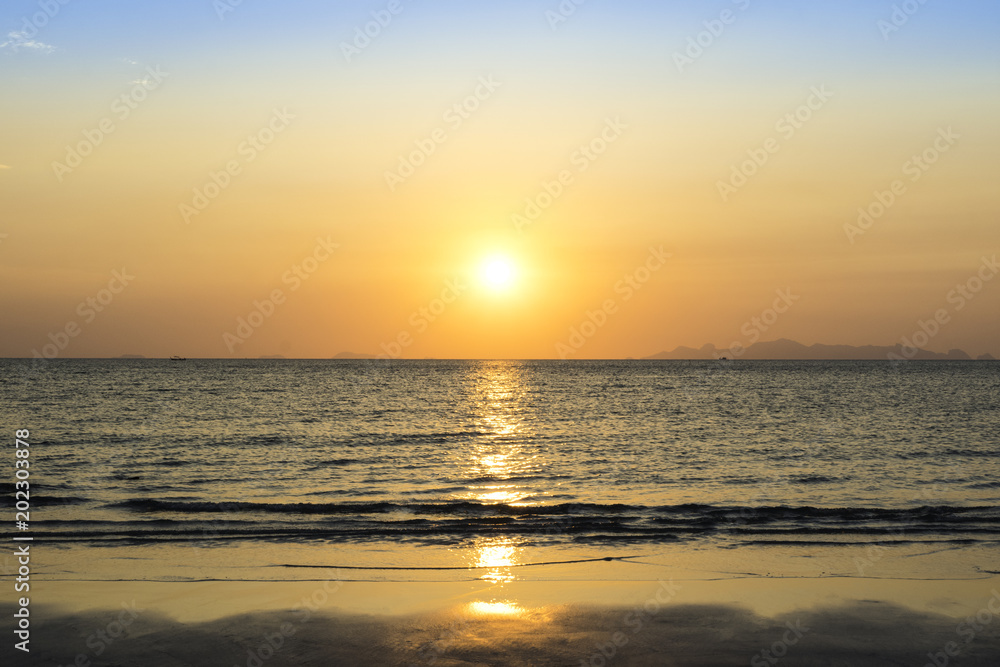 Beautiful sunset over sea and tropical beach in summer time. Natural background of sunset dawn and sunrise with bright dramatic scenic sky. Beautiful sunset over sea and tropical beach in summer time. Natural background of sunset dawn and sunrise with bright dramatic scenic sky.