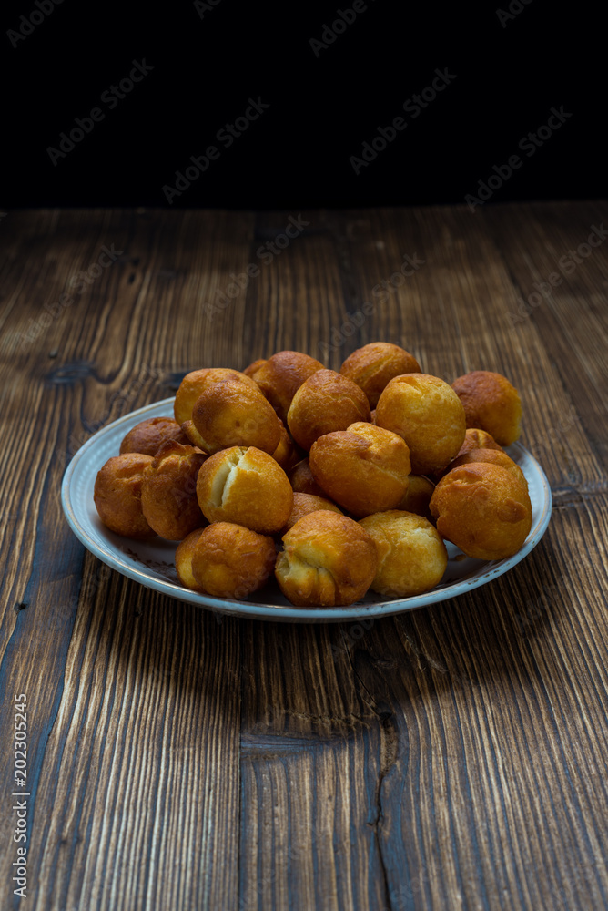 Small round donuts on wooden table Small round donuts on wooden table