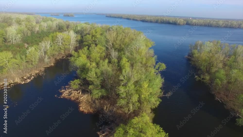 Aerial view of a large river during the spring flood in a sunny day. Aerial view of a large river during the spring flood in a sunny day.