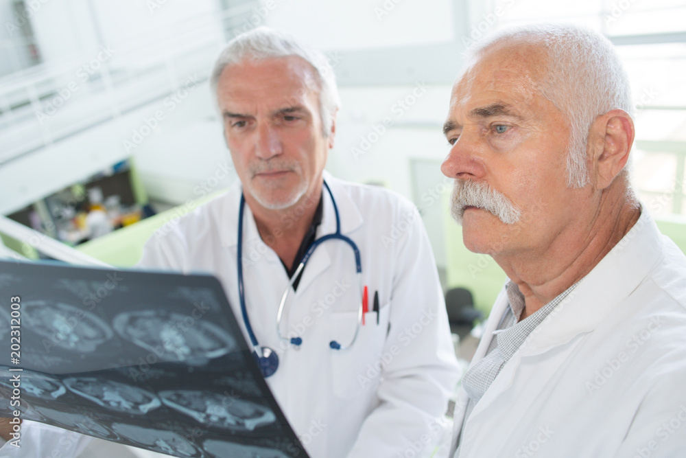 doctors studying a radiology result doctors studying a radiology result