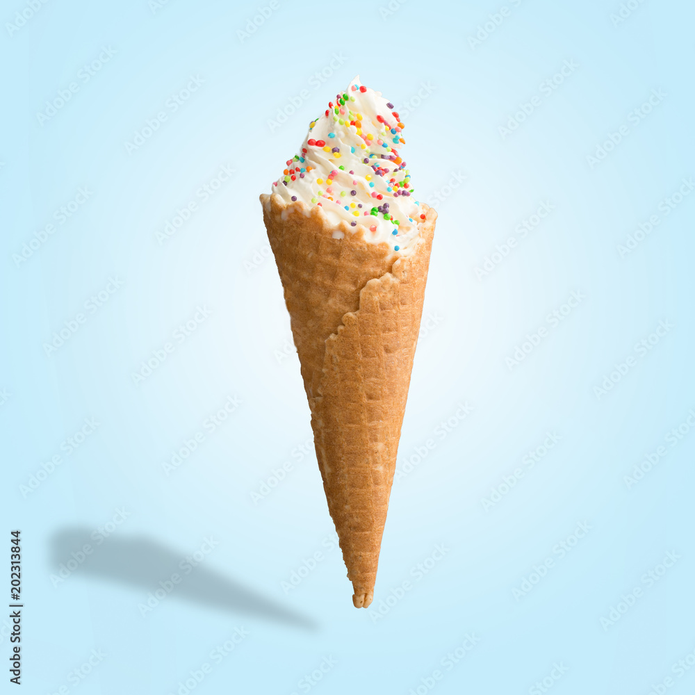 Vanilla ice cream with sweets in a waffle cone. Bright color, summer mood. Vanilla ice cream with sweets in a waffle cone. Bright color, summer mood.