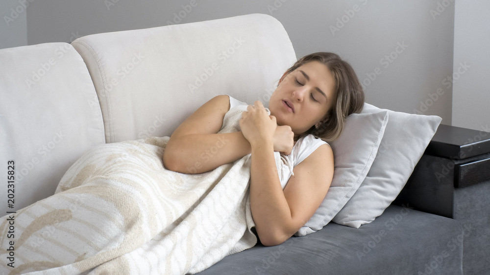 Portrait of ill woman lying on sofa at living room Portrait of ill woman lying on sofa at living room