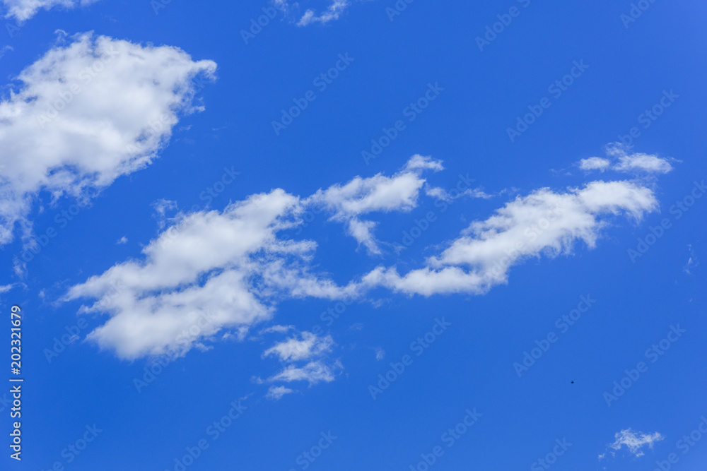 White fluffy clouds in a deep blue sky White fluffy clouds in a deep blue sky