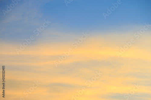 Twilight sky with golden clouds and blue sky.